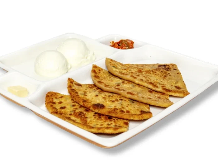 Neehee's Aloo Paratha meal platter, served with a side of curd and pickle.