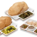 The close-up view of Neehee's Puri Bhaji, Undhiyu Puri and Gujarati Thali.